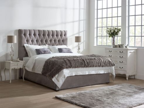 The Lloyd Fabric bed, upholstered in a stone colour Harbour grey fabric with a tall headboard with deep buttoning